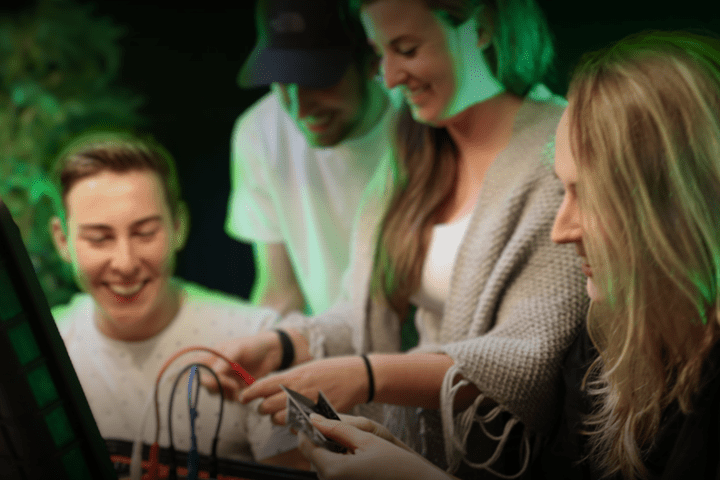 a group of people looking at a phone